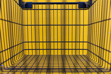 Minimalism style, Shopping cart black color and yellow wall at supermarket.の写真素材