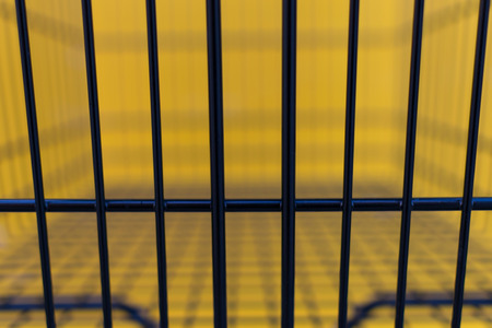 Minimalism style, Shopping cart black color and yellow wall at supermarket.