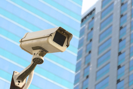 Security camera (CCTV) for safety on blue sky and city background , process in art water color styleの写真素材
