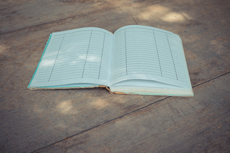 Vintage old Note book on a wood table , process in vintage styleの写真素材