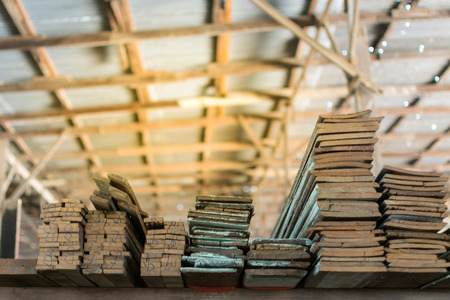 Slat and Timber wood from natural hardwood in warehouse for a construction , process in soft orange sun light styleの写真素材