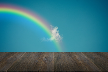 Nature cloudscape with blue sky and white cloud with Wood terrace and rainbow , process in vintage styleの写真素材