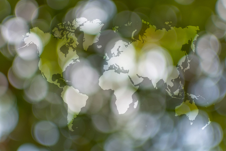 Abstract bokeh sunlight and tree background of nature in green color with world map
