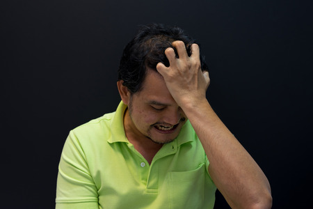 Anxious asian short hair man feeling sadness and stressの写真素材