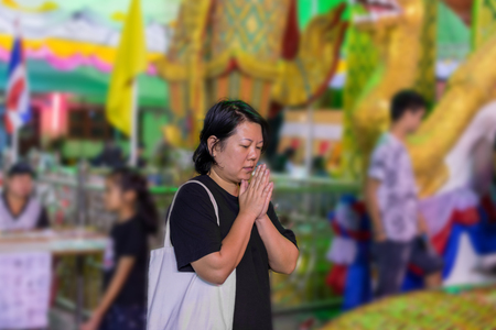 Thai buddhism people in buddhist pray for benefaction worship to Buddha in Thai templeの写真素材