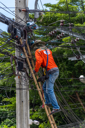 Bangkok, Thailand - June 26, 2016 : Unidentified worker working to install electric line by scaffolding on pickup truck at Bangkok Thailand.のeditorial素材
