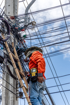 Bangkok, Thailand - June 26, 2016 : Unidentified worker working to install electric line by scaffolding on pickup truck at Bangkok Thailand.のeditorial素材