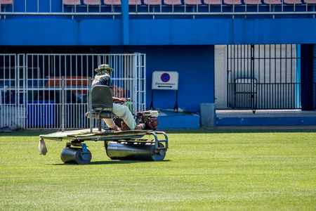 Bangkok, Thailand - February 17, 2017 : Unidentified man restoration the grass on a football stadium at PAT Stadium. PAT Stadium is a stadium in the Khlong Toei district Bangkok, Thailand.のeditorial素材