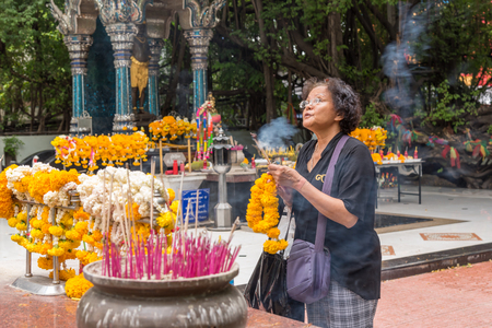 Bangkok, Thailand - March 28, 2017 : Unidentified Thai buddhism people in buddhist pray for benefaction worship by incense and garland to Buddha or spirit-house at shrine or Thai temple (Wat Thai)のeditorial素材