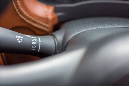 Car interior detail with car wiper controlling windshield and water switch control stick and...