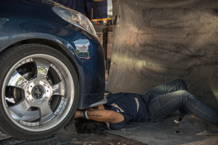 Bangkok, Thailand - April 9, 2017 : Unidentified car mechanic or serviceman checking a car engine for fix and repair problem at car garage or repair shopのeditorial素材