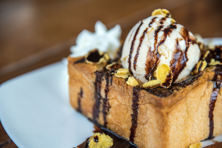 Honey toast with icecream and fruit topped with chocolate syrup and honey is a dessert tasty sweetの写真素材
