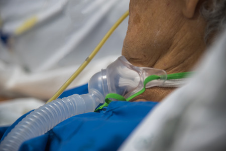 Patient asian elder women 80s do tracheostomy use ventilator for breathing help on bed in the...