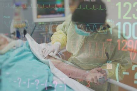 Asian women 40s years old in isolation gown non-sterile coat is a patient relative taking care of the CRE. or VRE. infected elder patient 80s years old on bed in the hospital with graph for heart rateの写真素材