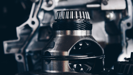 Disassembled car dirty engine close-up to engine parts and gear at car garage