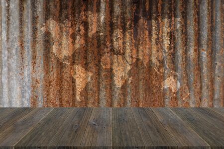 Metal rust wall texture background surface natural color with wood terrace with world mapの写真素材