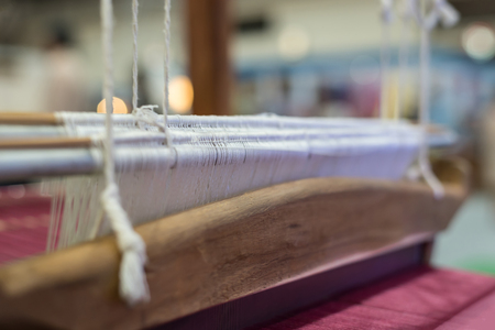 Traditional loom machine vintage style is tool for weave of making Thai silk from cocoon use by homemade in Laos and Thailandの写真素材