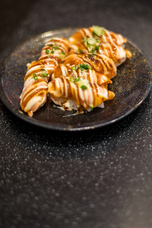 Japanese food in set different types of sushi with seaweed salad and gari (ginger) is a healthy food at the upper right of the serving board in japanese restaurantの写真素材