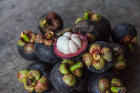 Mangosteen on a wood table is a queen of fruit in Thailand and asia fruit have a sweet can buy at Thai street food and fruit marketの写真素材