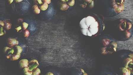 Mangosteen on a wood table is a queen of fruit in Thailand and asia fruit have a sweet can buy at Thai street food and fruit marketの写真素材