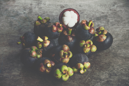 Mangosteen on a wood table is a queen of fruit in Thailand and asia fruit have a sweet can buy at Thai street food and fruit marketの写真素材