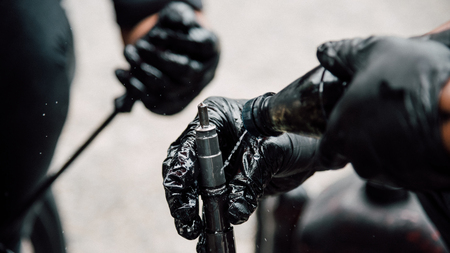Car mechanic or serviceman disassembled car dirty engine for cleaning fuel injection and air flow...