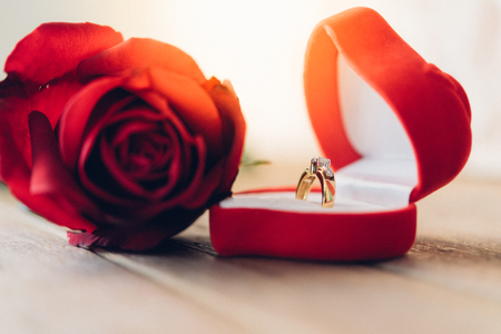 Red rose flower nature beautiful flowers from the garden and diamond necklace diamond ring accessories for marriage on wooden floor with copy space in Valentine's Day, Wedding or Romantic Love conceptの写真素材