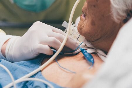 Patient asian elder women 80s do tracheostomy use ventilator for breathing help on bed in the...