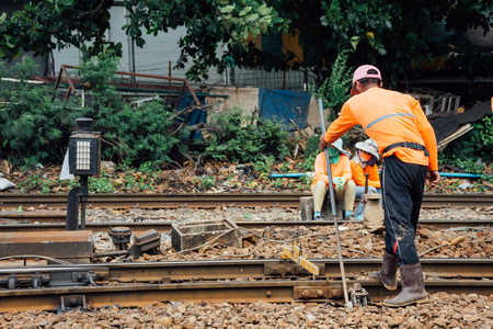 Railway employees working for restoration the railroad tracks in Bangkok station before serving at State Railway of Thailand.のeditorial素材