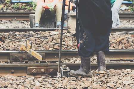 Railway employees working for restoration the railroad tracks in Bangkok station before serving at...