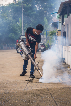 Bangkok, Thailand - July 3, 2016 : Unidentified people fogging DDT spray for mosquito kill and protect by control mosquito is a carrier of Malaria, Encephalitis, Dengue and Zika virus in village.のeditorial素材