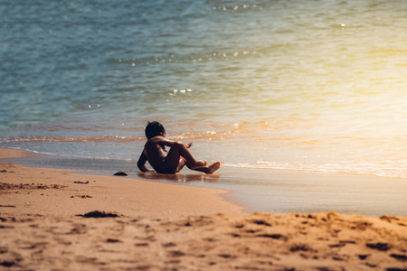 Rayong, Thailand - December 30, 2017 : Unidentified asian boy travel and playing with fun and happy at sea LaemMaePhim beach. This white sandy cape can be easily reached from city.の写真素材