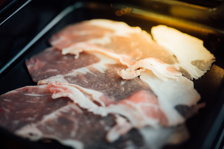 Beef raw meat slides on dish with barbecue sauce at BBQ. yakiniku grill buffet restaurant japanese foodの写真素材
