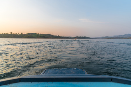 Tourist by sailing on Songkaria river by long tail boat with sun light in evening time when vacation...