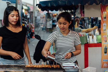Bangkok, Thailand -  April 26, 2018 : Unidentified chef cooking a Mala is Grilled meat (Beef, Pork, Chickens or Mushroom) with chilli sauce and sichuan pepper for sale at street food market.のeditorial素材