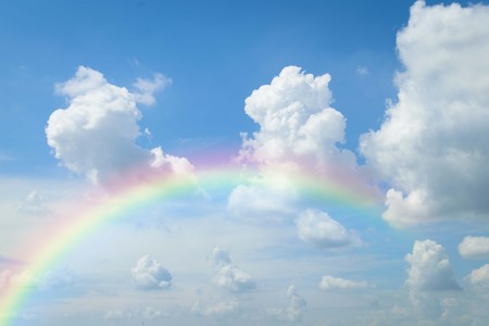 Cloudscape rainbow of natural sky with blue sky and white clouds and colorful rainbow in the sky use for wallpaper backgroundの写真素材