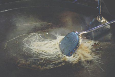 Fried noodle Thai style (Pad Thai) for sale at Thai street food market or restaurant in Thailandの写真素材