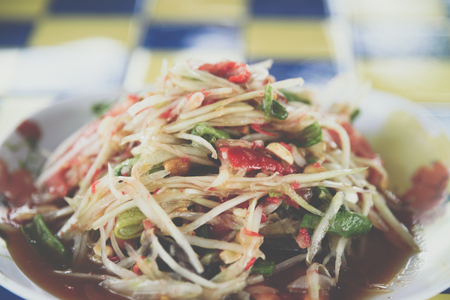 Papaya salad or Papaya Pok Pok (Som tum) for sale at Thai street food market or restaurant in Thailandの写真素材
