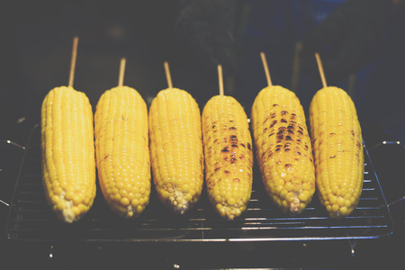 Roasted or Grilled Corn for sale at Thai street food market or restaurant in Thailandの写真素材
