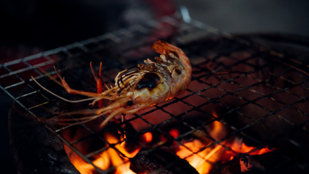 Grilled shrimp (Giant freshwater prawn) grilling with charcoal for sale at Thai street food market...