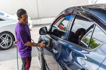 Bangkok, Thailand - October 10, 2018 : Unidentified car care staff cleaning (clean, wash, polish and...