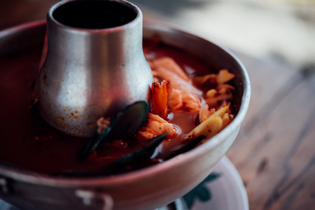 Prawn seafood spicy soup (Tom Yum Goong) is a famous Thai food have a spicy in Thai street food market at Bangkok Thailandの写真素材