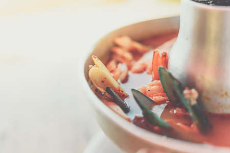 Prawn seafood spicy soup (Tom Yum Goong) is a famous Thai food have a spicy in Thai street food market at Bangkok Thailandの写真素材