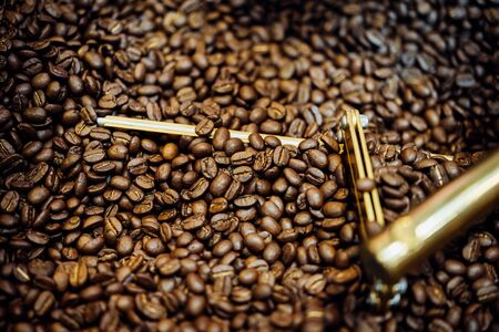 Coffee beans and roasted coffee beans roasting in roaster coffee beans machine at coffee shop cafe...