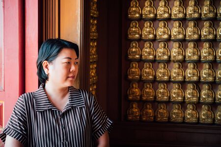 Asian woman 40s white skin plump body at Wat Boromracha Kanchanapisek Anusorn (Leng Noei Yi 2) is a Chinese temple under the patronage of the Chinese Buddhist Sangha in Thailand or Mahayana Buddhism.の写真素材