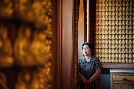 Asian woman 40s white skin plump body at Wat Boromracha Kanchanapisek Anusorn (Leng Noei Yi 2) is a Chinese temple under the patronage of the Chinese Buddhist Sangha in Thailand or Mahayana Buddhism.の写真素材