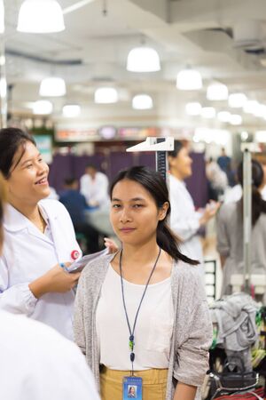 Bangkok, Thailand - May 31, 2019 : Unidentified Asian woman health check by body weight and height...