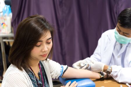 Bangkok, Thailand - May 30, 2019 : Unidentified Asian woman health check by blood test every year by the Ministry of Health.のeditorial素材