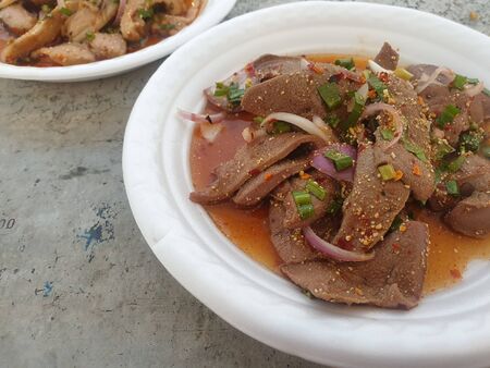 Spicy Pork Liver Salad (Tub Wan) is a Thai Esan food for sale at Thai street food market or restaurant in Thailandの写真素材