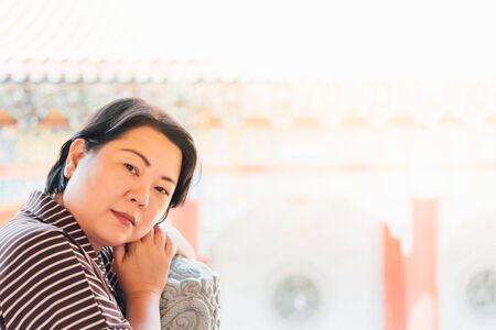 Asian woman 40s white skin plump body at Wat Boromracha Kanchanapisek Anusorn (Leng Noei Yi 2) is a Chinese temple under the patronage of the Chinese Buddhist Sangha in Thailand or Mahayana Buddhism.の写真素材